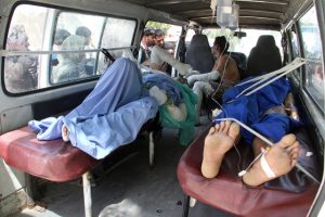 epa05294357 Afghan men, who were injured in a road accident, are brought to local hospital in Ghazni, Afghanistan, 08 May 2016. Fifty-two people were killed and at least 73 injured when two buses collided with a fuel tanker on 08 May in Kabul highway, an official said.  EPA/SAYED MUSTAFA