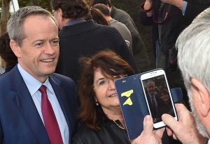 Labor Party leader Bill Shorten (L) poses for a picture with one of his constituents in Melbourne on July 2, 2016. Australians flocked to vote in national elections on July 2 with conservative leader Malcolm Turnbull appearing to have a slight edge over Labor's Bill Shorten, culminating a marathon race where economic management has become a key issue in the wake of the Brexit vote. / AFP PHOTO / Paul Crock