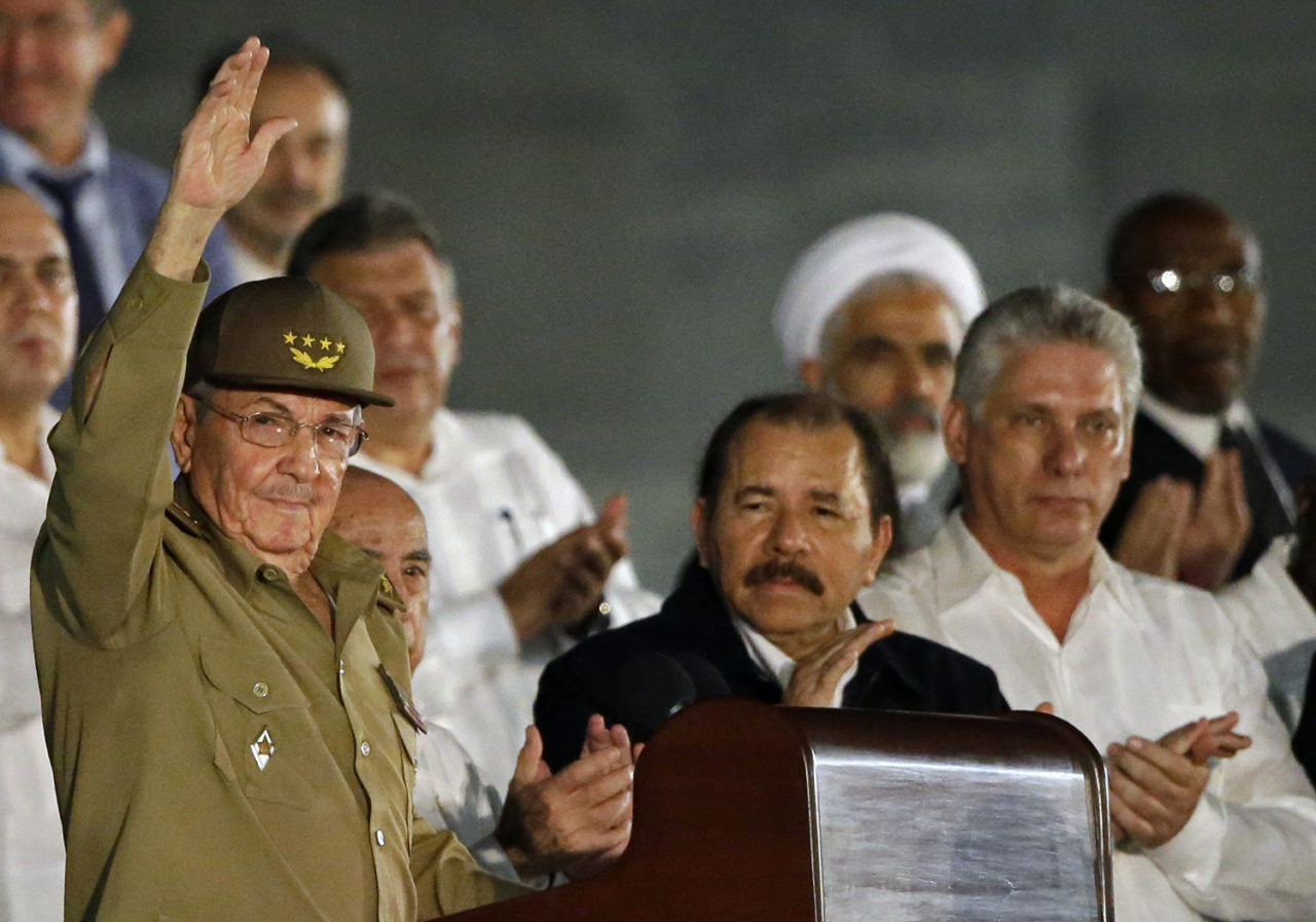 Cuba's President Raul Castro waves as he arrives to a rally honoring his deceased brother Fidel Castro at the Revolution Plaza in Havana, Cuba, Tuesday, Nov. 29, 2016. Schools and government offices were closed Tuesday for a second day of homage to Fidel Castro, with the day ending in a rally on the wide plaza where the Cuban leader delivered fiery speeches to mammoth crowds in the years after he seized power. Fidel Castro passed away Friday Nov. 25. He was 90. First from right Cuba's First Vice President Miguel Diaz-Canel, at center Nicaragua's President Daniel Ortega. (AP Photo/Ricardo Mazalan)